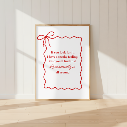 Love Actually quote wall art print with elegant red bow design in light oak frame.