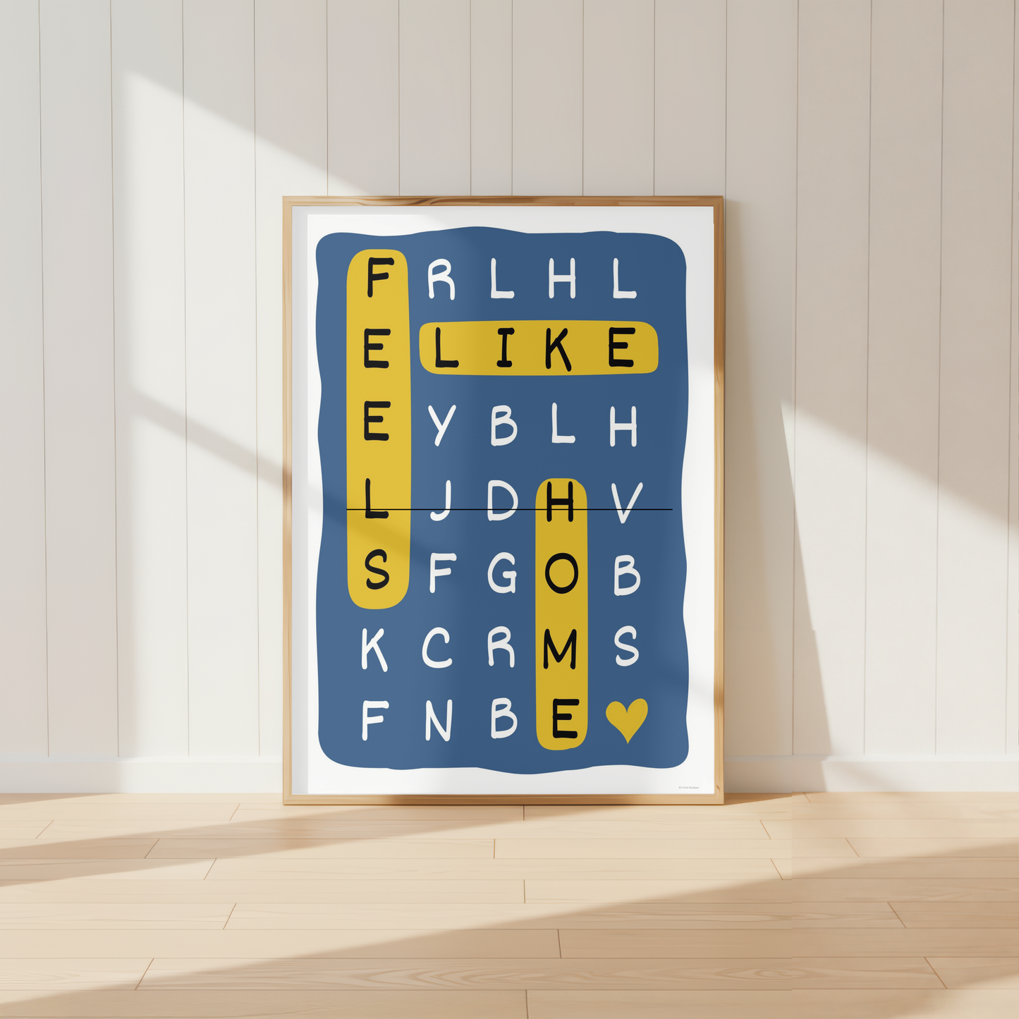 Modern family word search wall art featuring the phrase "Feels Like Home" in blue and mustard yellow tones.