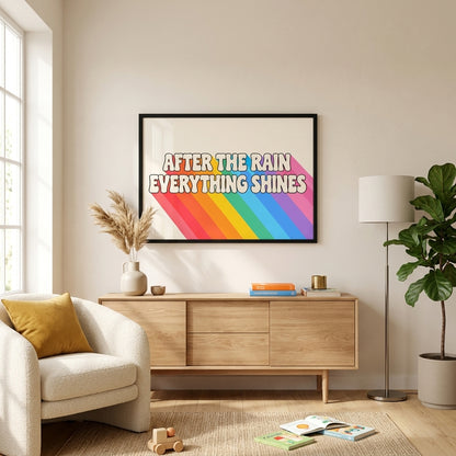A framed art print with the text 'AFTER THE RAIN EVERYTHING SHINES' and a rainbow design, displayed on a beige wall in a modern living room setting above a wooden sideboard.