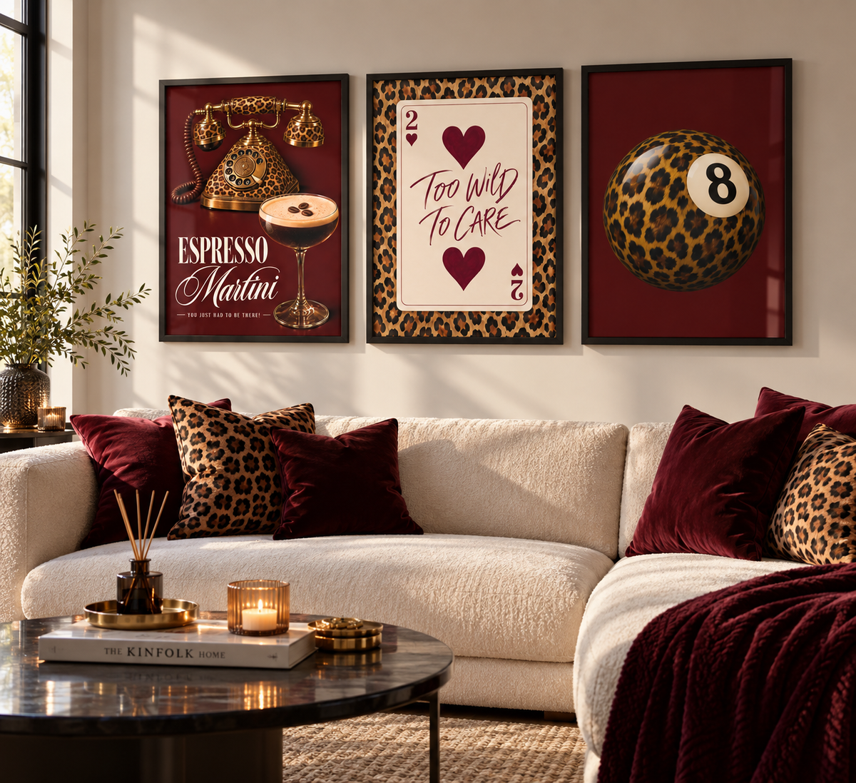 Three framed wall art prints with a cohesive retro gaming and cocktail theme hang above a cream sectional sofa with burgundy and leopard-print pillows in a styled living room.