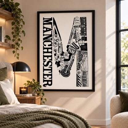 A framed black and white Manchester cityscape art print hangs on a beige wall in a modern bedroom setting with a bed, bedside lamp, and window visible.
