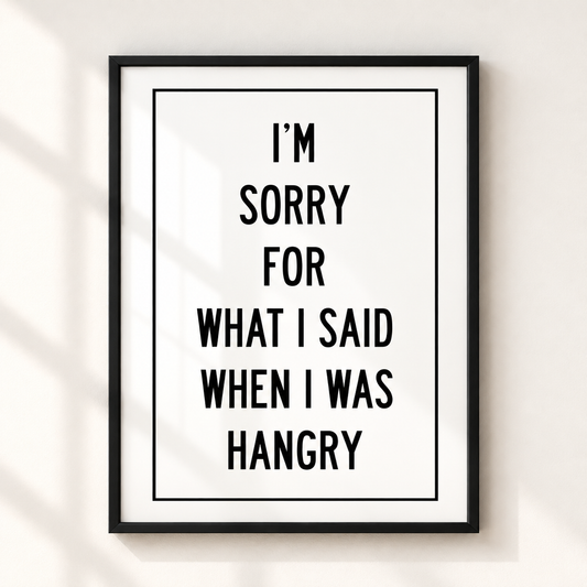 I'm Sorry for What I Said When I Was Hangry funny quote print in a thin black frame on an ivory wall with minimalist typography