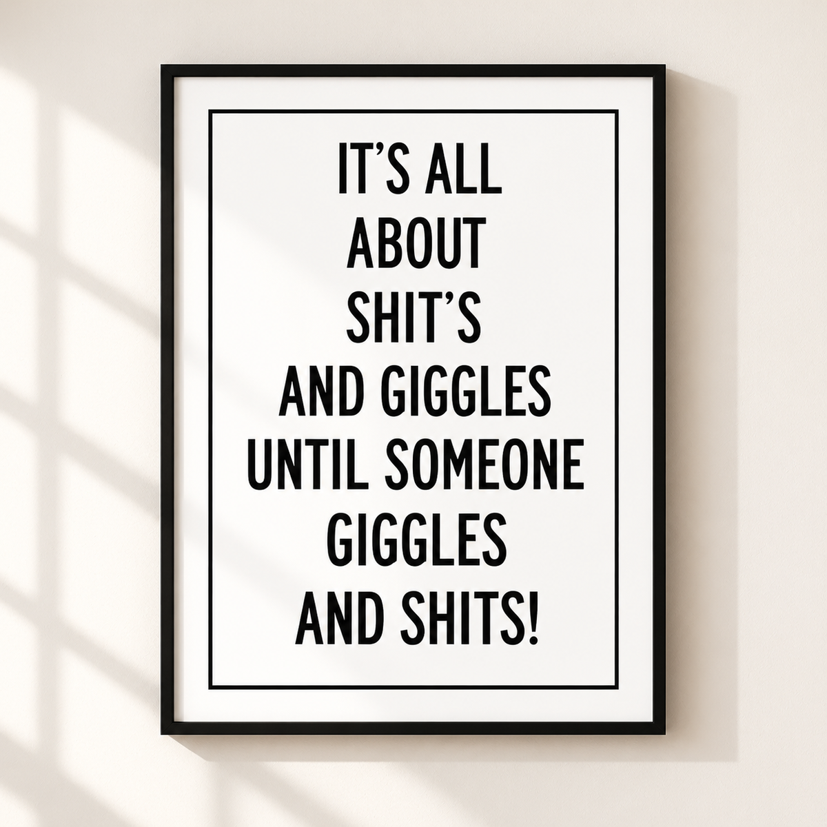 Shits and Giggles funny quote typography print in a thin black frame on a warm ivory wall with minimalist monochrome styling