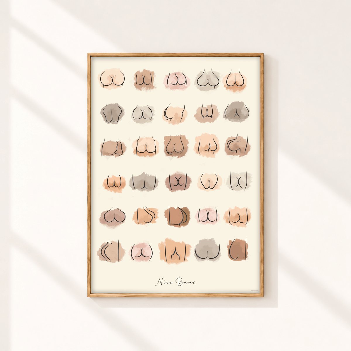 Nice Bums funny bathroom wall art print with neutral watercolour bum illustrations displayed in a slim natural oak frame