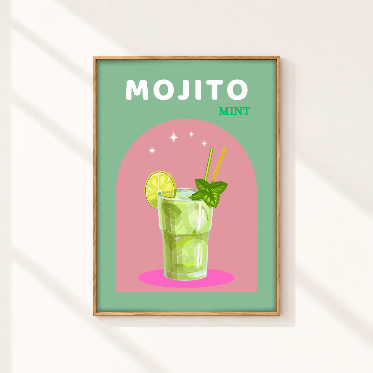 A framed art print featuring a colorful illustration of a mojito mint cocktail, displayed on a light beige wall with soft diagonal shadows.