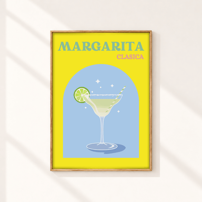 A framed art print featuring a retro-style illustration of a margarita cocktail with the text 'MARGARITA CLASICA' on a bright yellow background, hanging on a light wall with soft diagonal shadows.