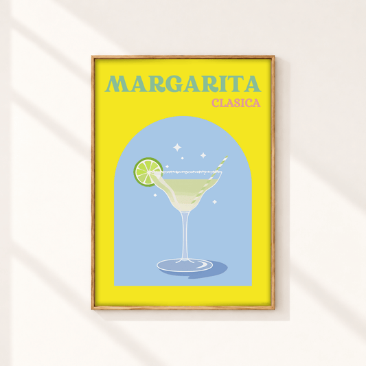 A framed art print featuring a retro-style illustration of a margarita cocktail with the text 'MARGARITA CLASICA' on a bright yellow background, hanging on a light wall with soft diagonal shadows.