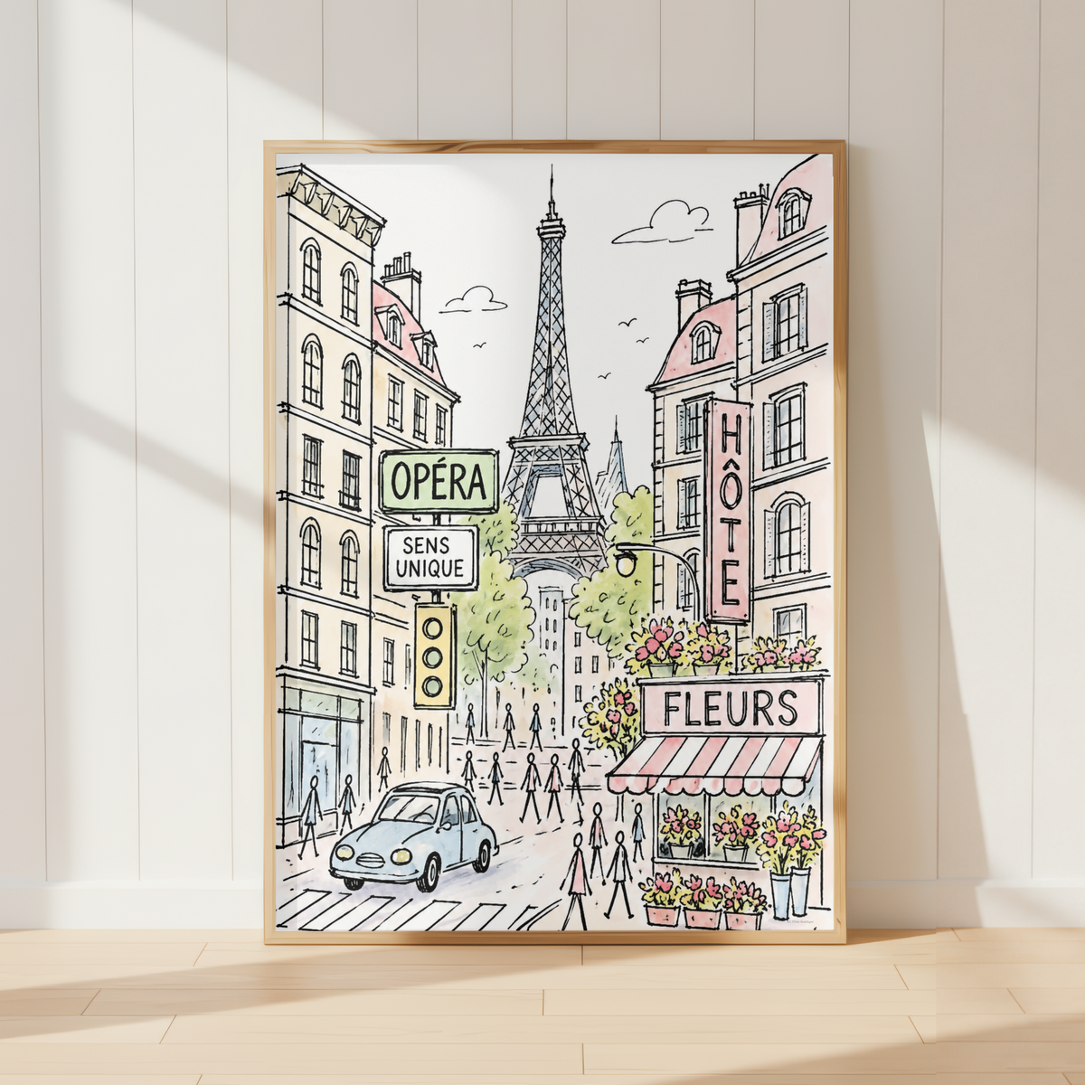 A framed art print depicting a Parisian street scene with the Eiffel Tower, hand-drawn buildings, and storefronts, leaning against a white paneled wall on a light wood floor.