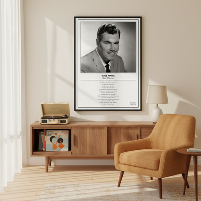 A framed black-and-white portrait print of Rose Marie as Slim Whitman leaning against a white paneled wall on a light wood floor. The print includes a black frame, a black-and-white photo, the name and role, and a block of small text below.