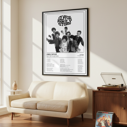 A framed black-and-white music poster for Sly and the Family Stone's 'Family Affair' leaning against a white paneled wall on a light wood floor, with soft window shadows cast across the scene.