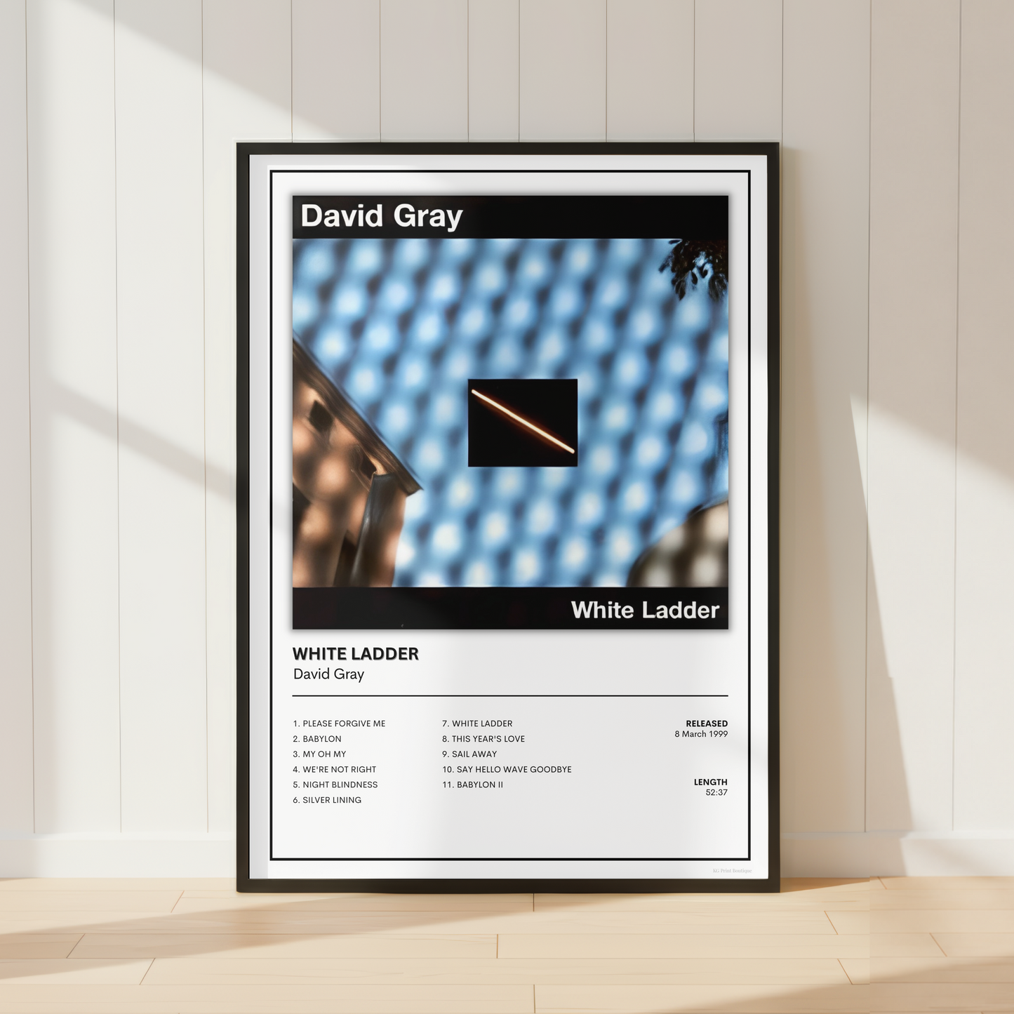David Gray White Ladder album tracklist poster displayed in a modern bedroom home office with neutral décor, vinyl records and contemporary furnishings.