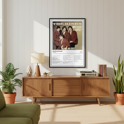 A framed music poster of The Kinks' 'Waterloo Sunset' leaning against a white paneled wall on a light wood floor, with soft window shadows cast across the scene.