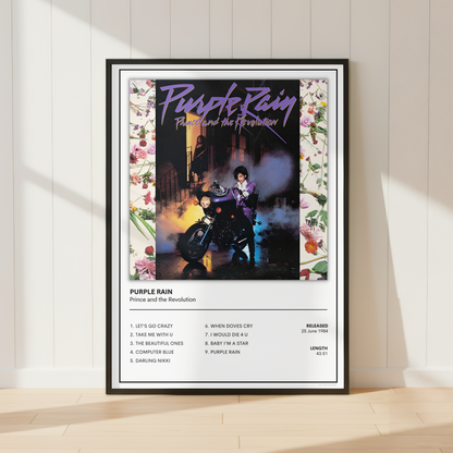 A framed music poster of Prince, Purple Rain leaning against a white paneled wall on a light wood floor, with soft sunlight casting shadows across the scene.