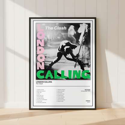 A framed music poster of The Clash's 'London Calling' leaning against a white paneled wall on a light wood floor, with soft sunlight casting shadows across the scene.