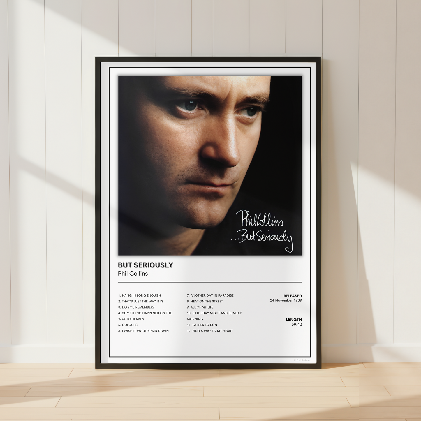 Phil Collins ...But Seriously album cover poster displayed in a sleek black frame, featuring the iconic artwork and complete track listing in a minimalist music print.