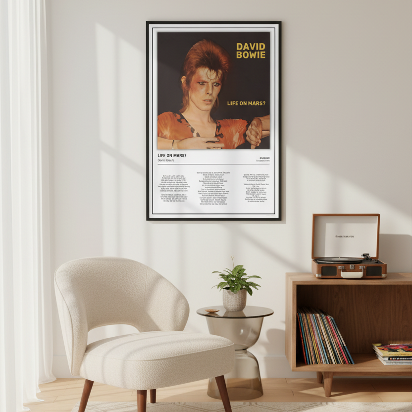 A framed David Bowie 'Life on Mars?' poster hangs on a light beige wall in a styled living room with a cream armchair, a small side table with a plant, and a wooden record stand.