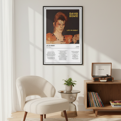 A framed David Bowie 'Life on Mars?' poster hangs on a light beige wall in a styled living room with a cream armchair, a small side table with a plant, and a wooden record stand.