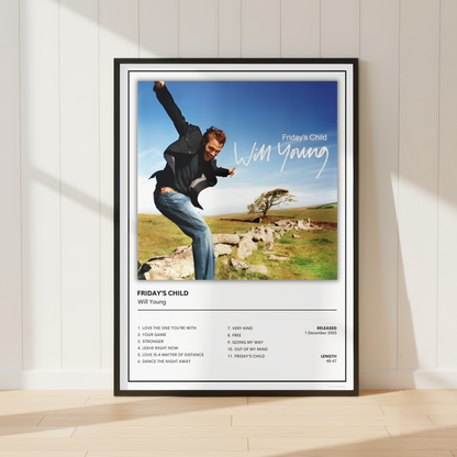 A framed music poster for the band Friday's Child and artist Will Young, leaning against a white paneled wall on a light wood floor. The poster features a photo of Will Young jumping outdoors with the band's name and track list printed below.