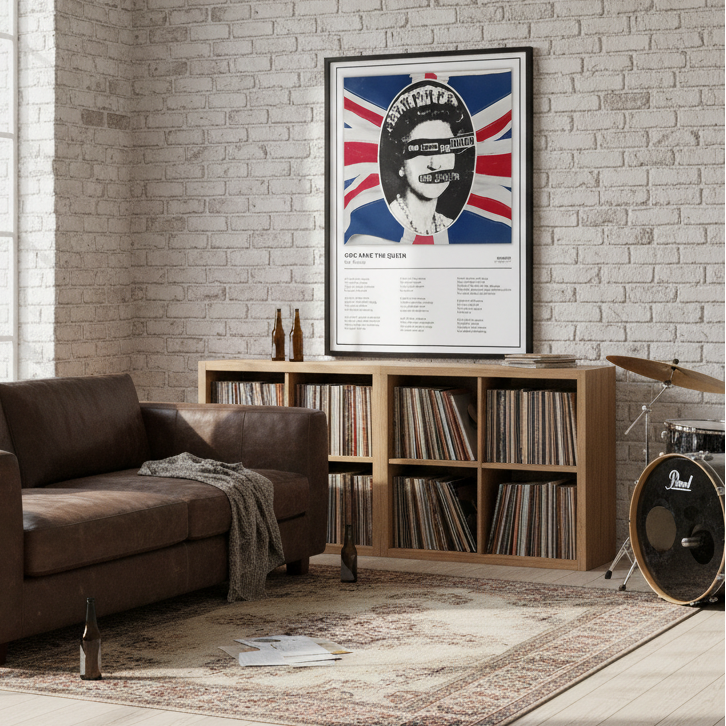 A framed music poster of Queen's 'God Save the Queen' leaning against a white paneled wall on a light wood floor, featuring a stylized portrait over a Union Jack background.