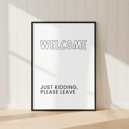 Funny Welcome Just Kidding Please Leave wall art print featuring minimalist black and white typography.