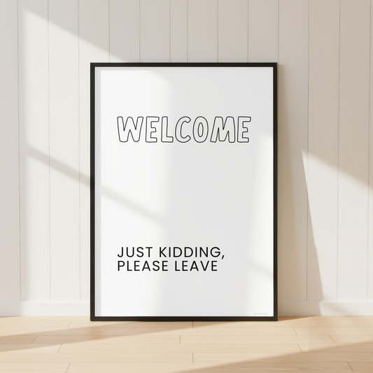 Funny Welcome Just Kidding Please Leave wall art print featuring minimalist black and white typography.