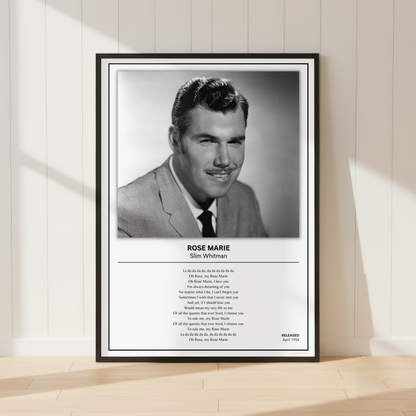 A framed black-and-white portrait print of Rose Marie as Slim Whitman leaning against a white paneled wall on a light wood floor. The print includes a black frame, a black-and-white photo, the name and role, and a block of small text below.