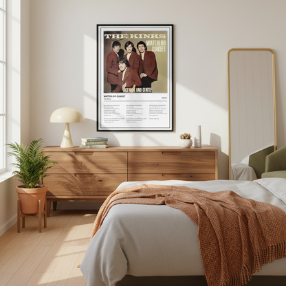 A framed music poster of The Kinks' 'Waterloo Sunset' leaning against a white paneled wall on a light wood floor, with soft window shadows cast across the scene.