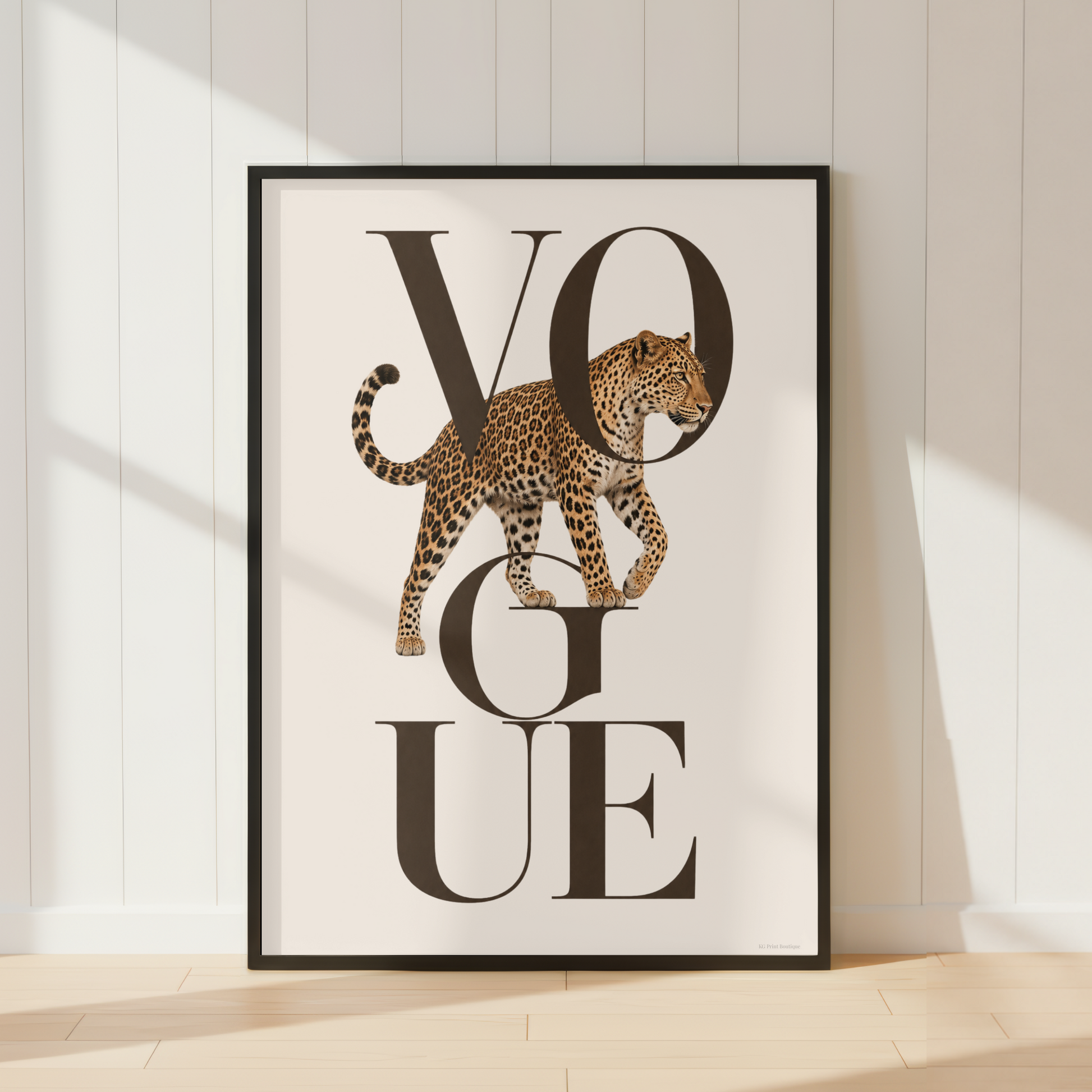 Luxury Vogue leopard wall art featuring elegant black typography and a realistic leopard illustration in warm neutral tones, displayed with a warm ivory mount and black frame.