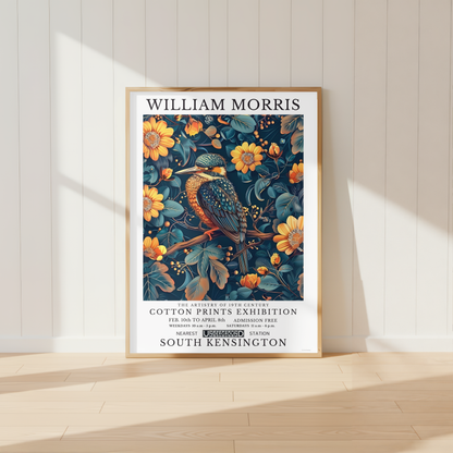 William Morris inspired kingfisher print displayed above a wooden desk in a neutral home office with botanical decor and warm natural lighting.