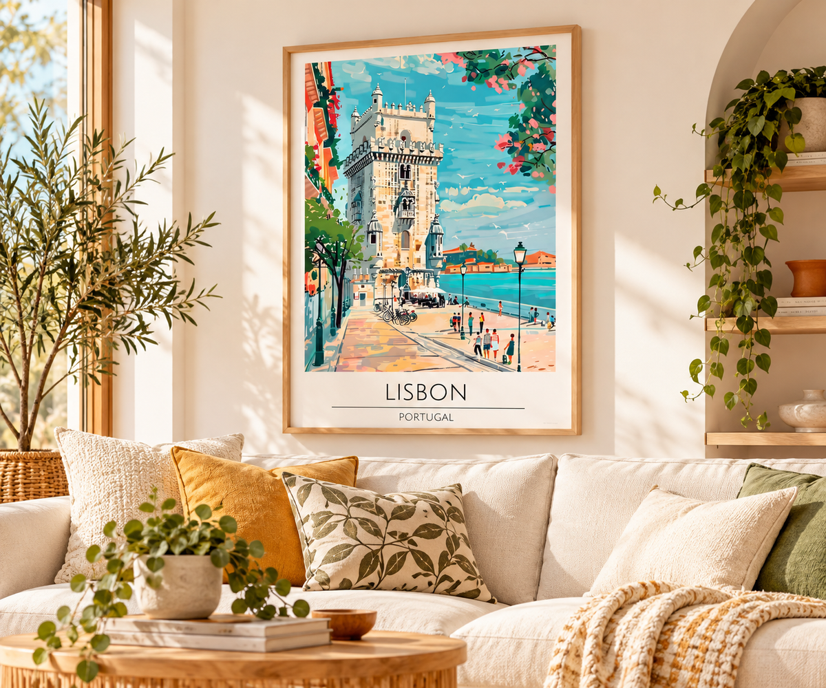 A framed Lisbon travel poster hangs on a beige wall above a white sofa in a bright, modern living room. The poster features a colorful illustration of the Beira Tower and waterfront walkway, with the text 'LISBON PORTUGAL' at the bottom.