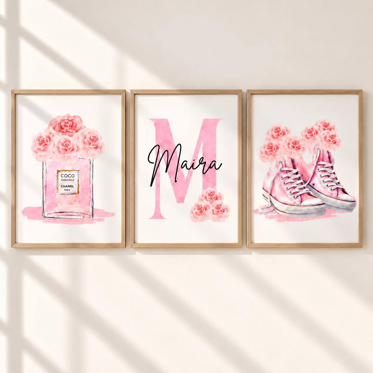 Three framed watercolor art prints hanging on a wall. The left print shows pink roses in a perfume bottle labeled Coco Chanel.