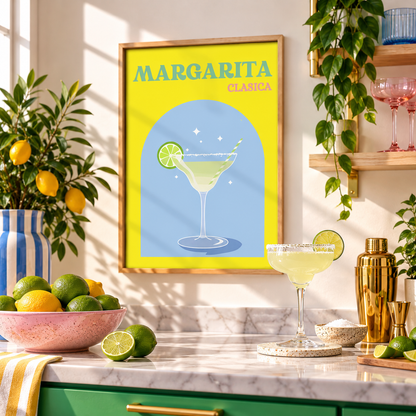 A framed 'Margarita Clásica' art print hangs on a kitchen wall above a marble counter with a margarita glass, lime slices, a shaker, and greenery.