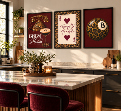 Three framed wall art prints hang above a kitchen island in a modern kitchen setting. The left print features a vintage gold martini glass with the text 'ESPRESSO Martini' on a dark red background.